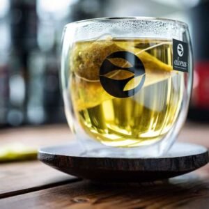 Tekopp på et kaffebord med grønn te og mint.